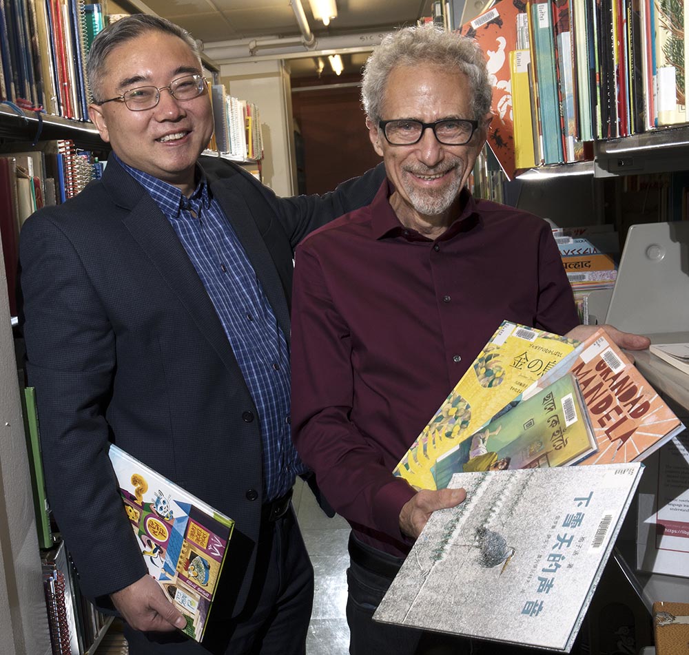 Curator Tao Yang and Marc Aronson show off the collection at Alexander Library.